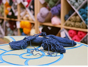 Knitting in progress laying on a table in the shape of an ammonite.