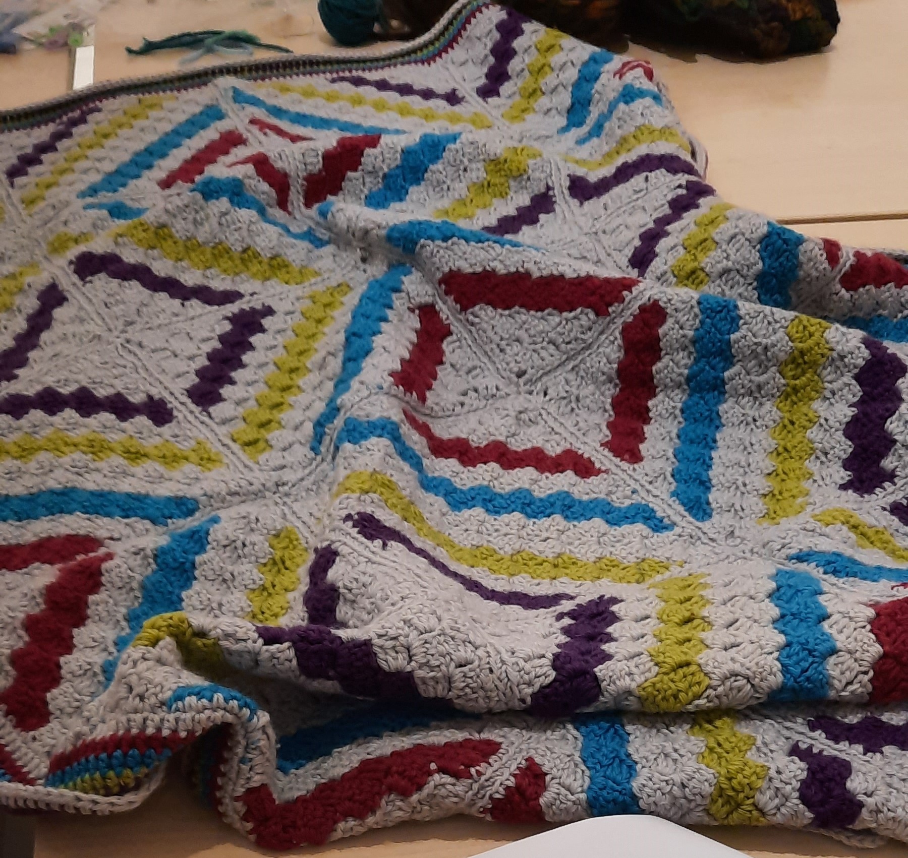 Afghan blanket made from corner-to-corner crochet squares.