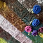 Patchwork knitting embellished with flowers