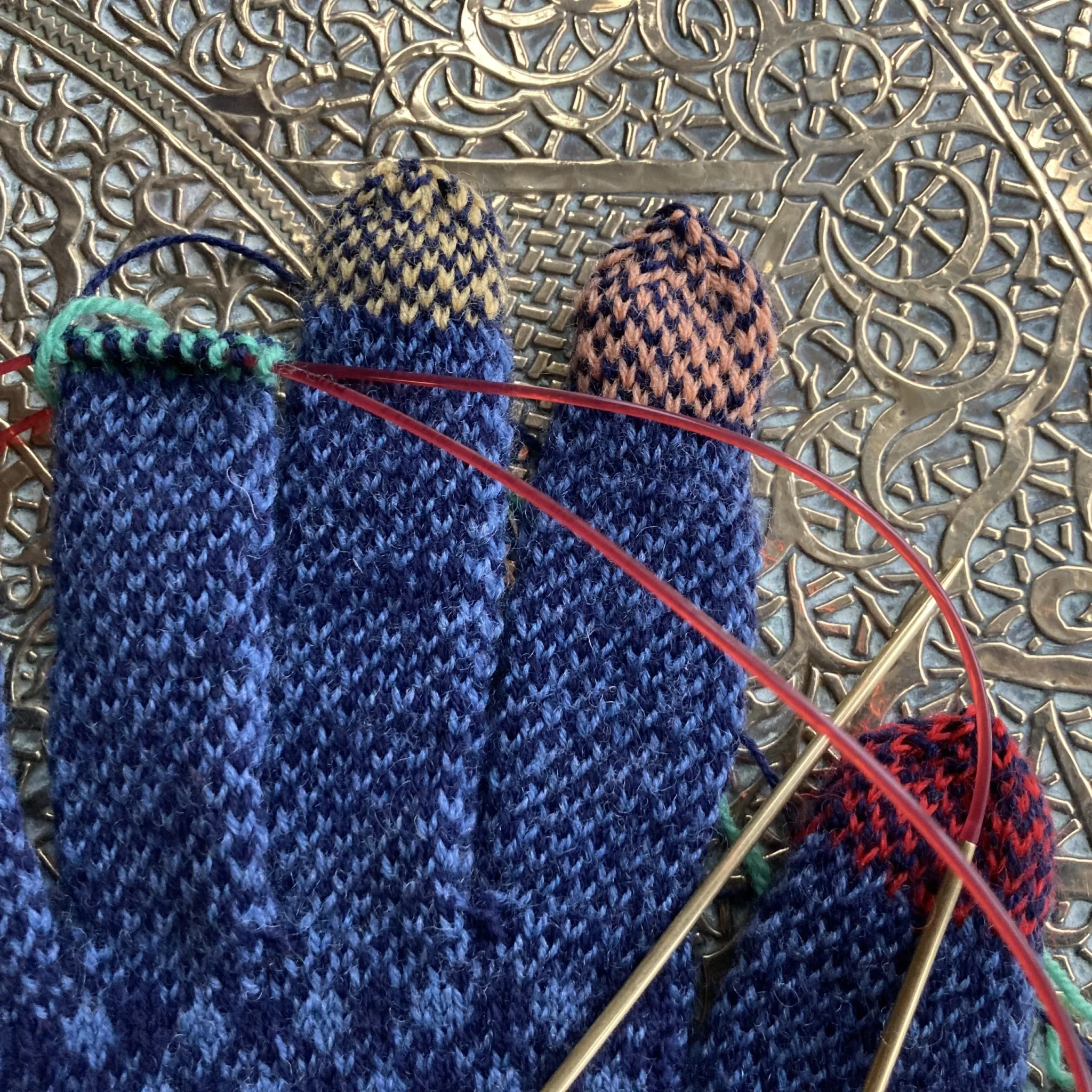 Rainbow Fingertips for Sanquhar Gloves on Antique Brass Table.