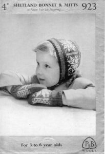 Young child wearing bonnet and mittens in Fair Isle star pattern