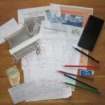 Pattern, swatch, pencils, measurement template, and other items used in adapting a pattern
