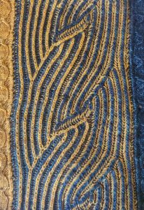 Photograph of syncopated brioche in blue and gold.