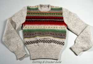 A Bohus product sweater, round neck, finely knitted in light natural wool and seven colours.