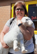 Photo of Kelly Ferguson carrying a toy lamb