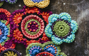 Crochet flowers in assorted colours with features highlighted bybeads.